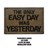 A brown embroidered patch with black text that reads THE ONLY EASY DAY WAS YESTERDAY