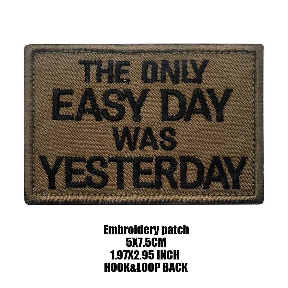A brown embroidered patch with black text that reads THE ONLY EASY DAY WAS YESTERDAY
