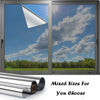A window with one-way privacy film installed, showing a bright sky and green landscape.