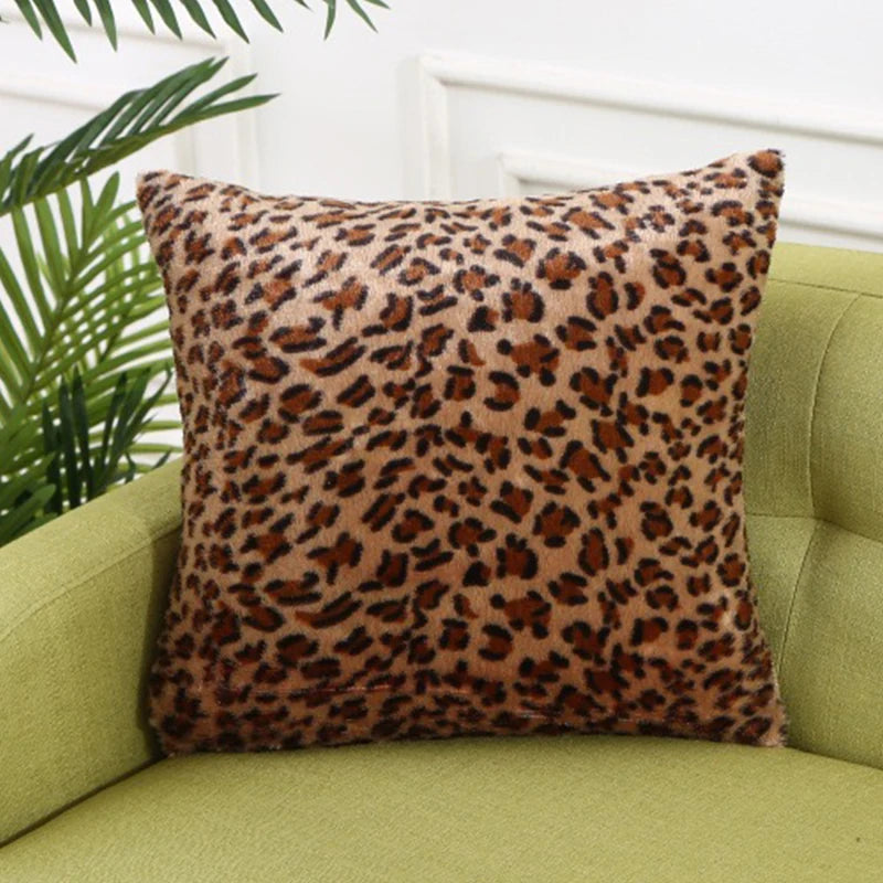 A close-up of a brown leopard print throw pillow resting on a light green sofa.