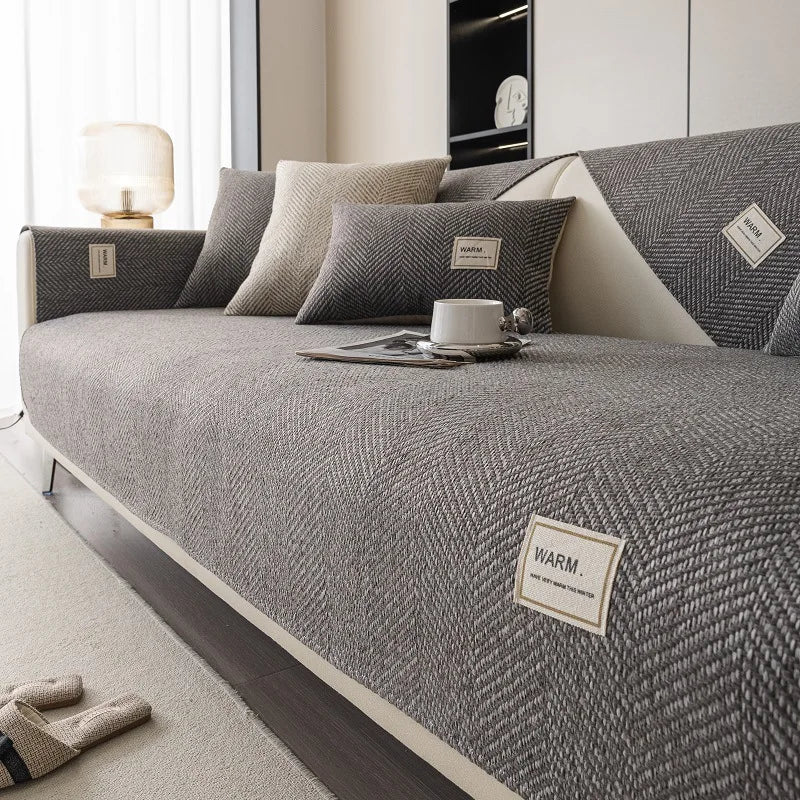 A gray linen sofa cover cushion with a textured weave rests on a light-colored floor.