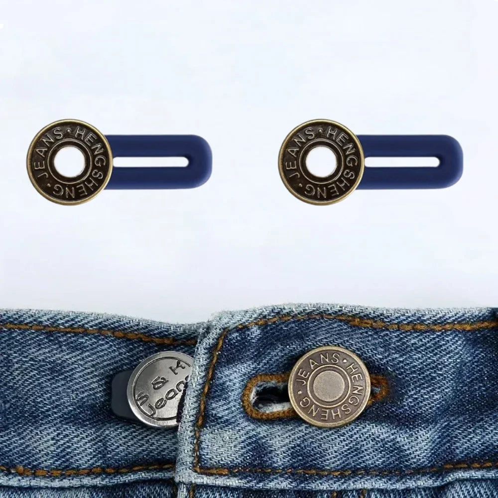 A pair of brass jean buttons with a hexagonal design are shown against a denim fabric.