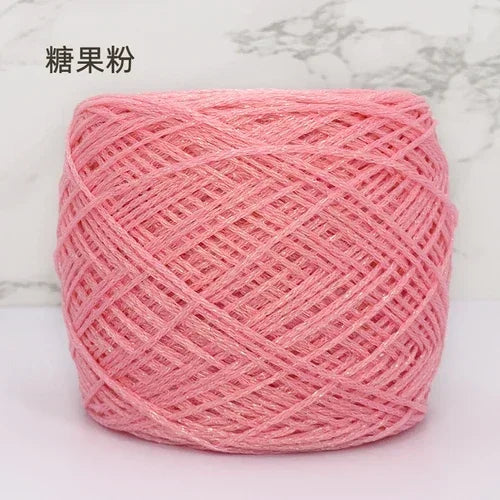 Pink metallic silk crocheting and knitting yarn in a ball