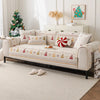A beige sofa with decorative patterned seat covers and a Christmas tree in the background.