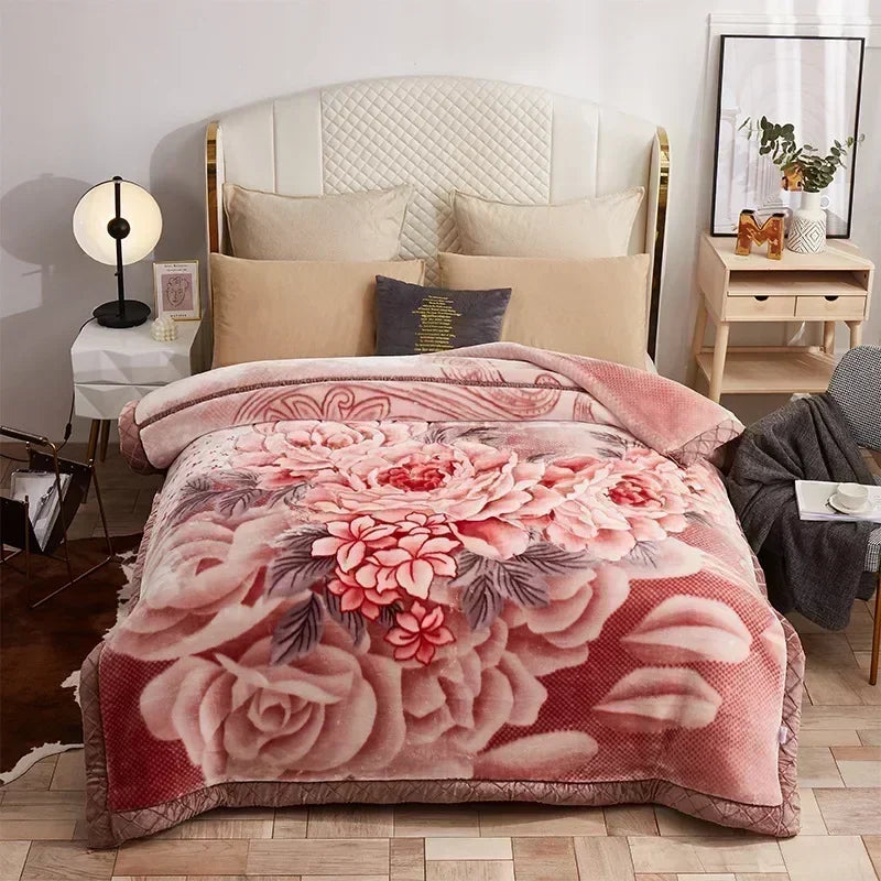 A pink floral weighted blanket displayed on a bed with white and beige bedding.