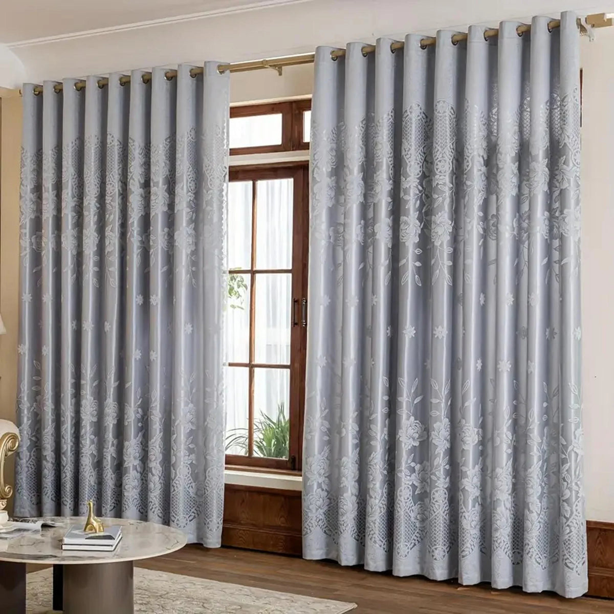Light gray vintage floral blackout curtain panels hanging in a window frame.