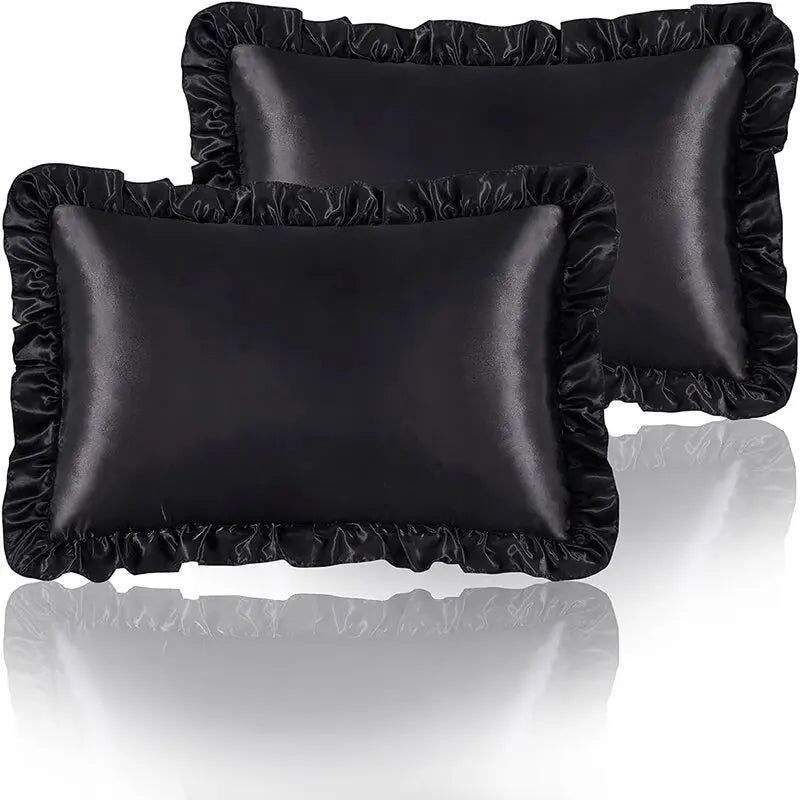 A set of two black ruffled satin pillowcases with silky envelope closures.