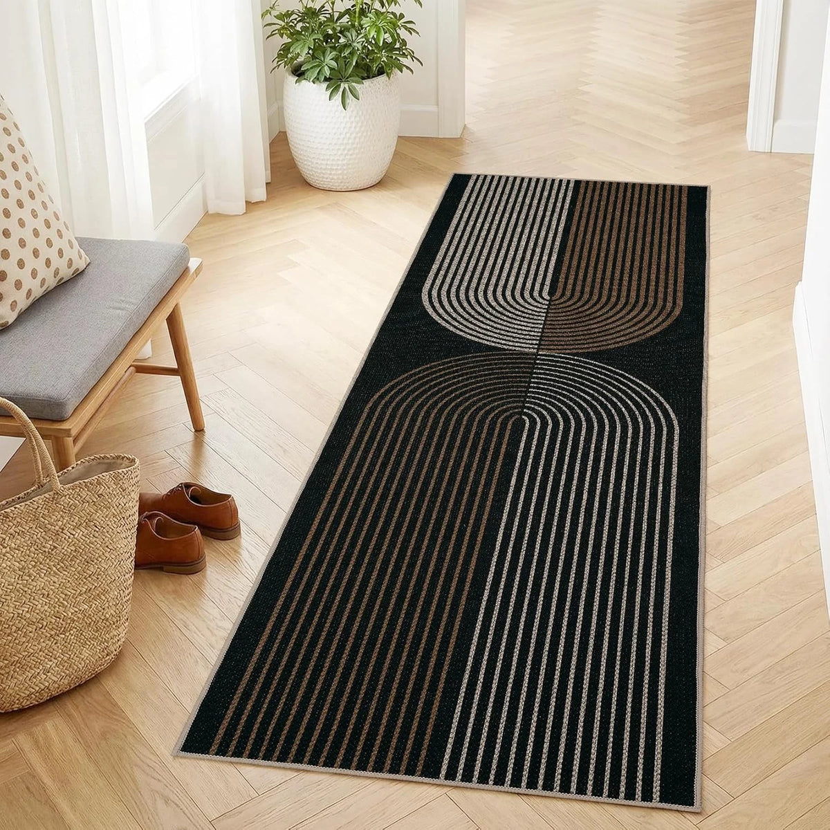 A long runner rug with black and beige geometric lines laid on a light wood floor.