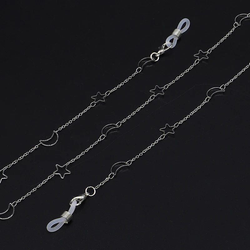Silver locket necklace featuring stars and moons on a delicate chain