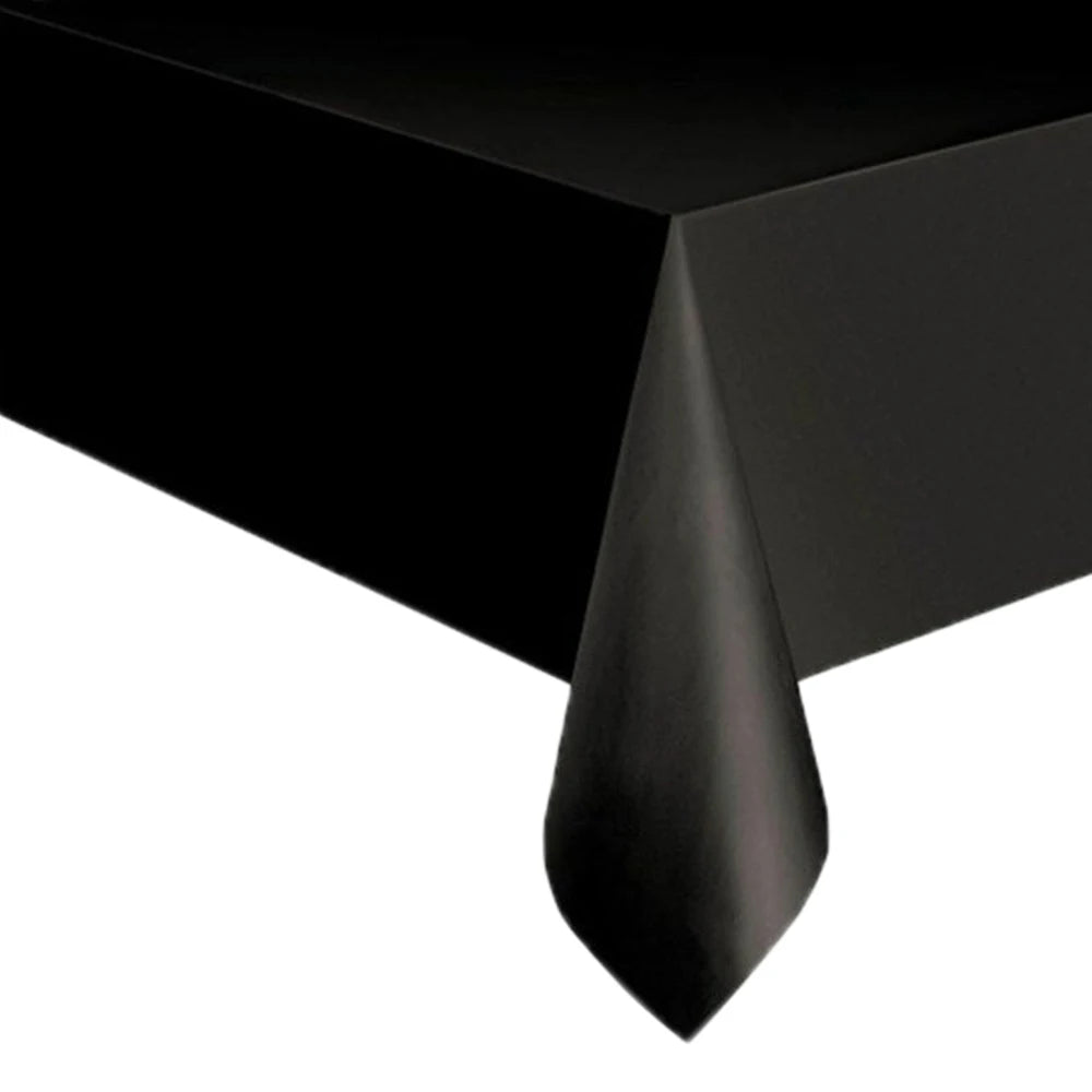 Black cow print disposable plastic tablecloth draped over a table.