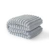 A stack of soft gray striped flannel throw blankets folded neatly.