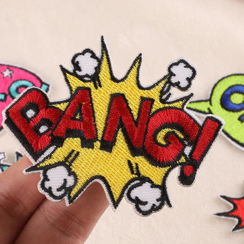 A red and yellow embroidery patch with the word BANG displayed on a light fabric background.