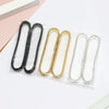 A collection of metal sleeve garters or adjustable arm bands in black, gold, and silver are displayed on a white background.