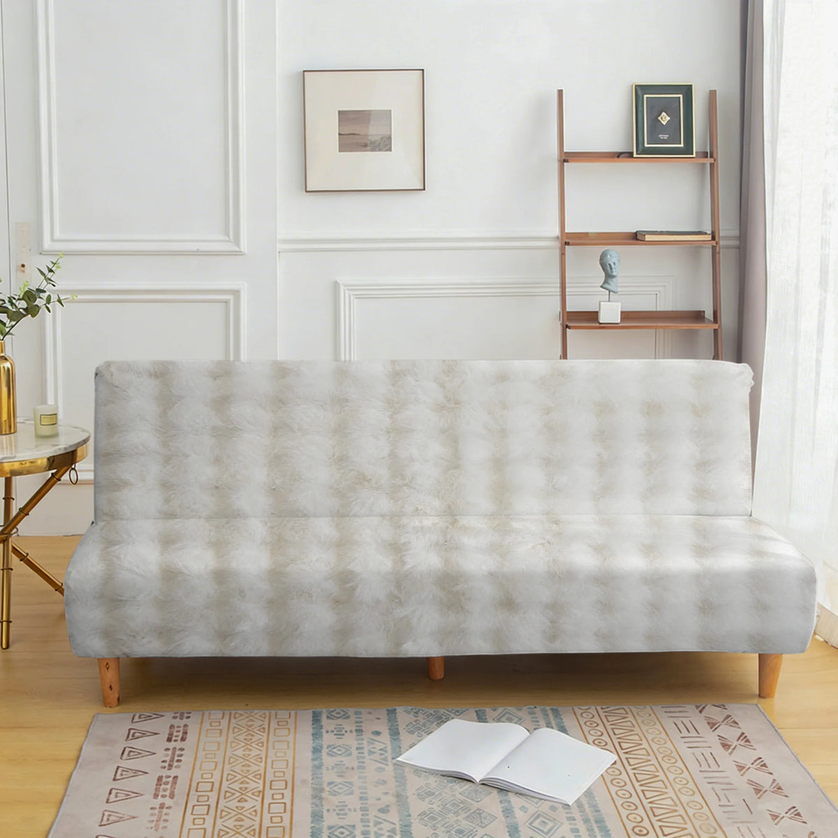 A light beige velvet non-slip armless sofa cover displayed on a wooden floor with a patterned rug.