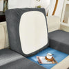 A gray jacquard sofa slipcover with an oval white cushion placed on a light-colored sofa.