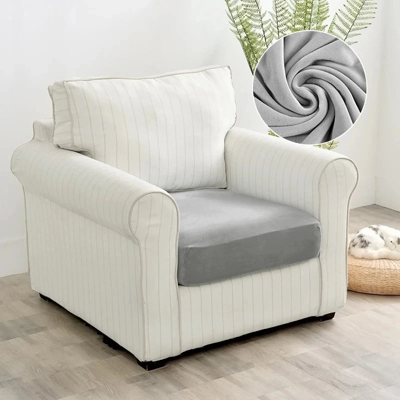 A cream upholstered armchair with a gray seat cushion and vertical stripes, set against a light background.