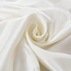 White satin fabric in a striped pattern is elegantly draped and rolled.