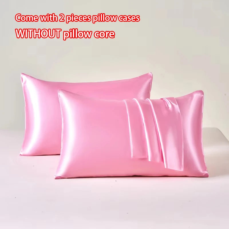 Two pink satin pillow cases without a pillow core displayed on a white surface.