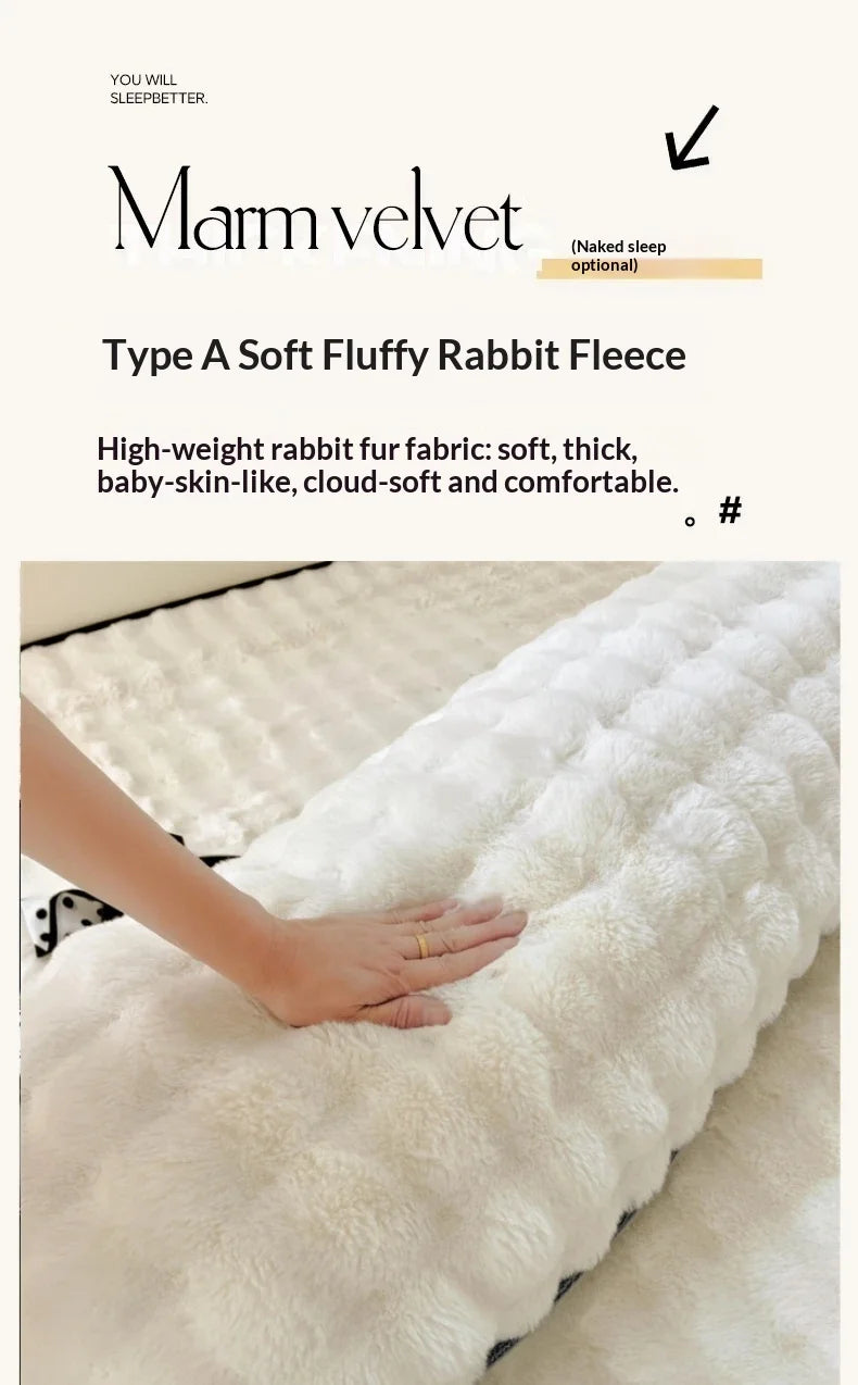 A close-up of a white rabbit fleece blanket being held, showing its fluffy texture and soft fibers.