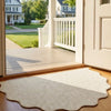 A natural jute non-slip entrance door mat placed on a wooden floor near a white exterior door.