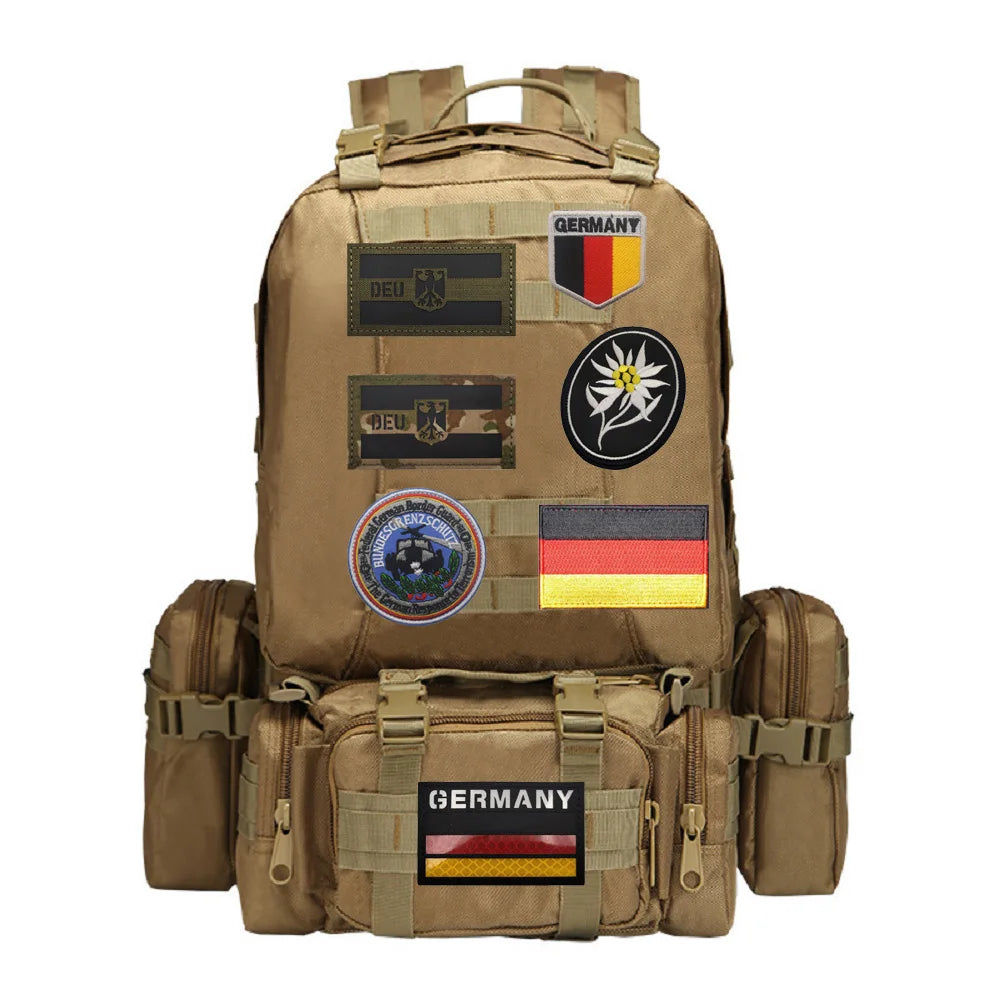 A tan backpack featuring multiple embroidered patches with German flags and symbols.