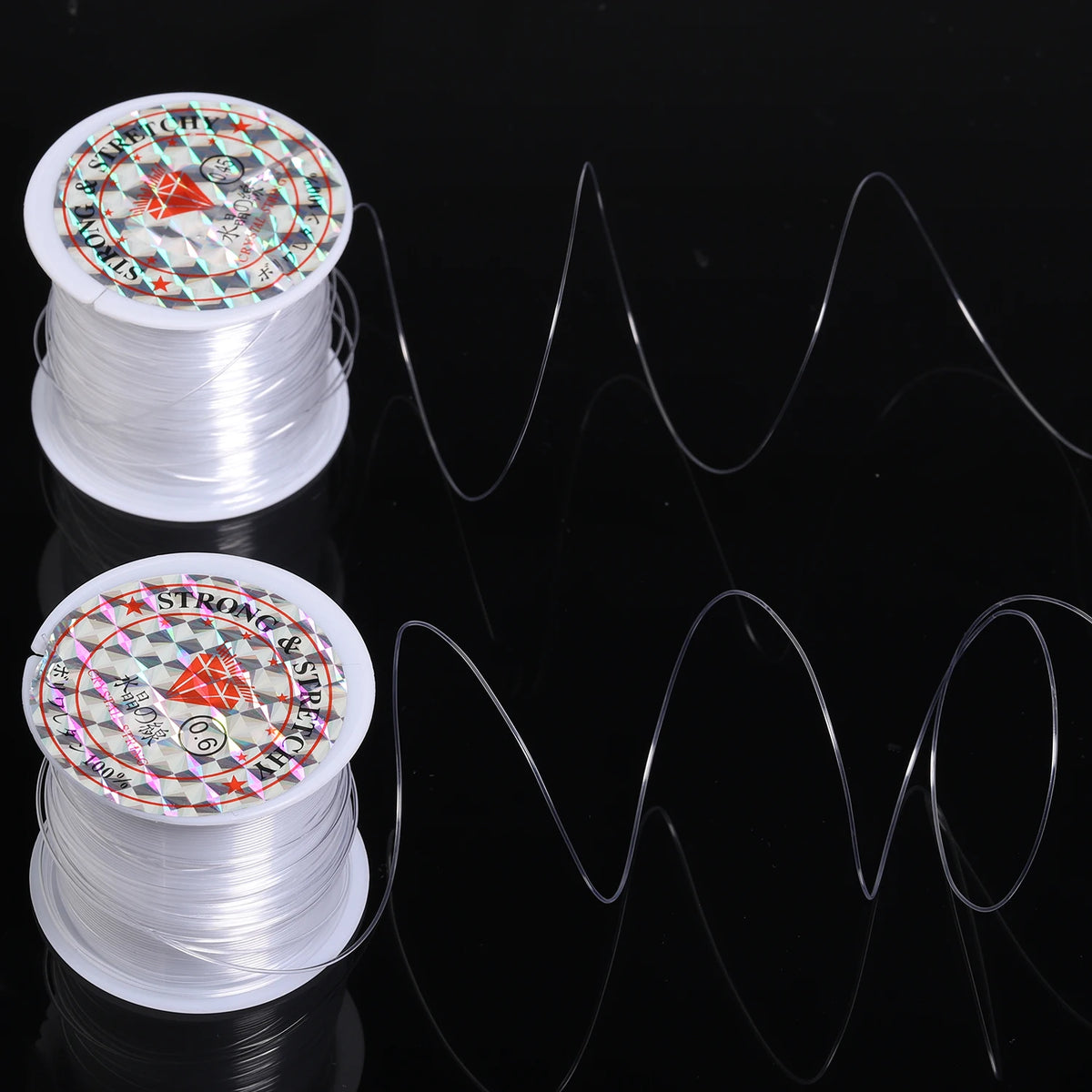 Two spools of precision nylon beading thread for jewelry making with decorative labels