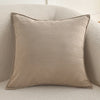 A beige luxury chenille throw pillow cover resting on a light-colored, textured sofa.