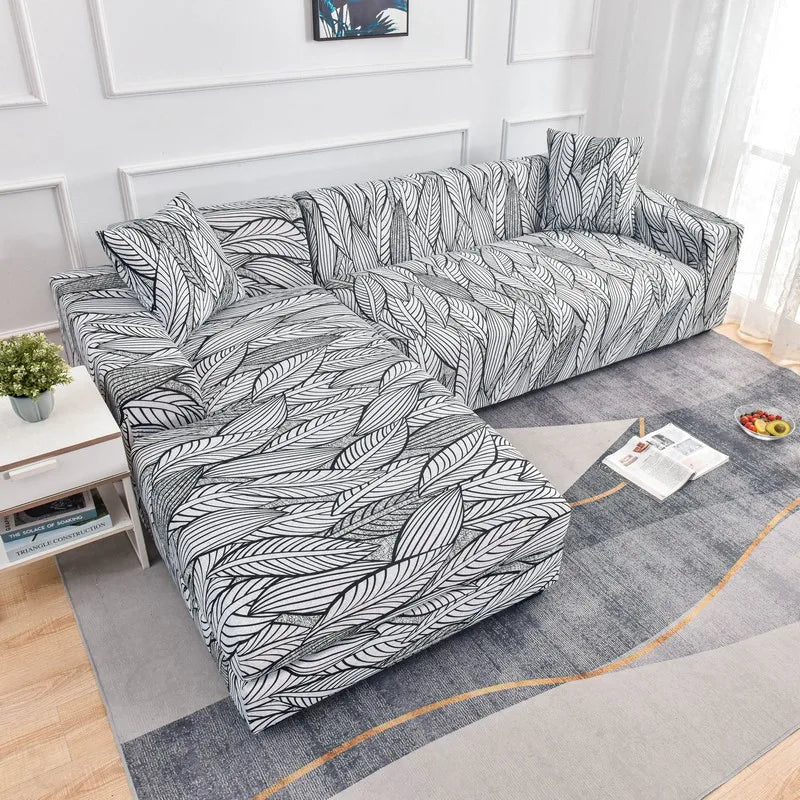 L-shaped sofa protector covers featuring a black and white leaf pattern on a gray fabric.