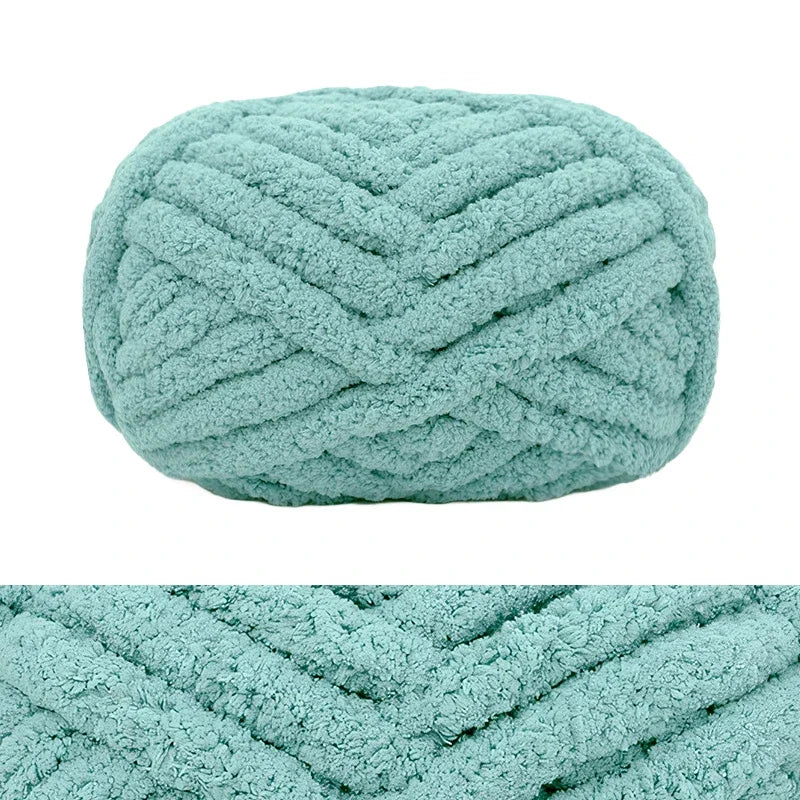 A light mint green hand-knitted wool finger line scarf with a textured, braided pattern.