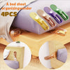 Four silicone bed sheet organizers in various colors used to lift and organize bedding on a mattress.