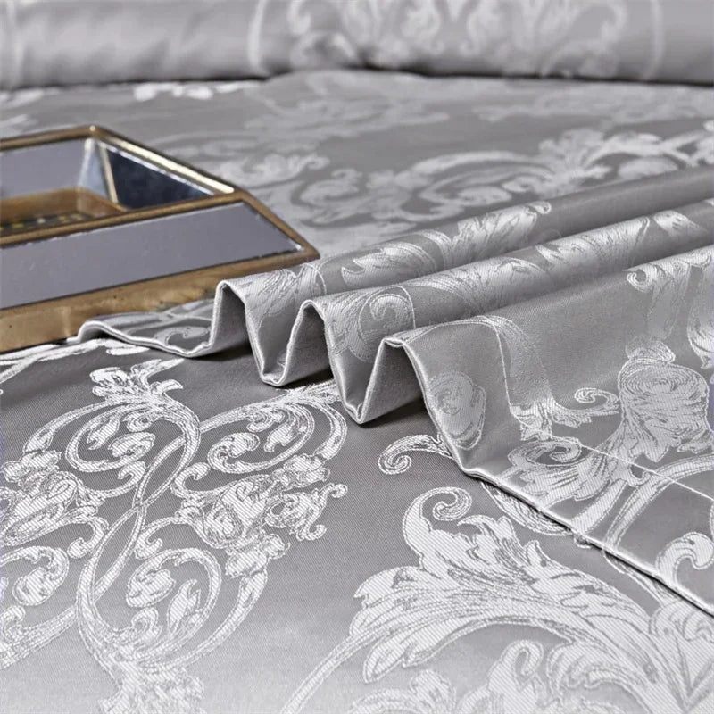 Gray luxury duvet cover set featuring ornate white floral embroidery and a metallic tray