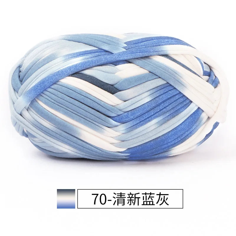 A ball of hand-dyed fabric strip yarn featuring blue and white stripes for crochet and knitting.