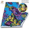 A vibrant blue fabric featuring a detailed African wax print design with purple, yellow, and green floral patterns.
