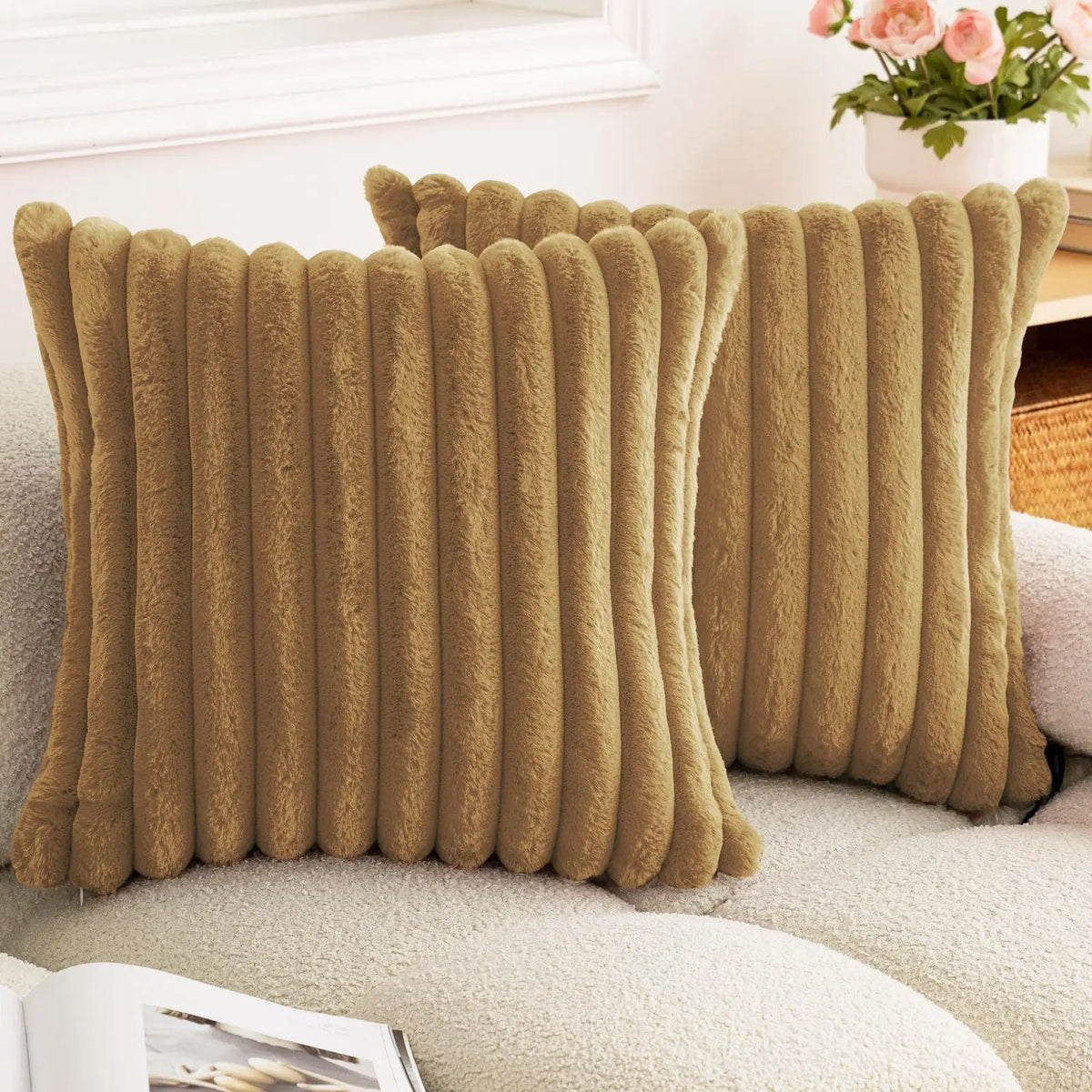 A textured, olive brown faux rabbit fur cushion cover resting on a light-colored sofa.