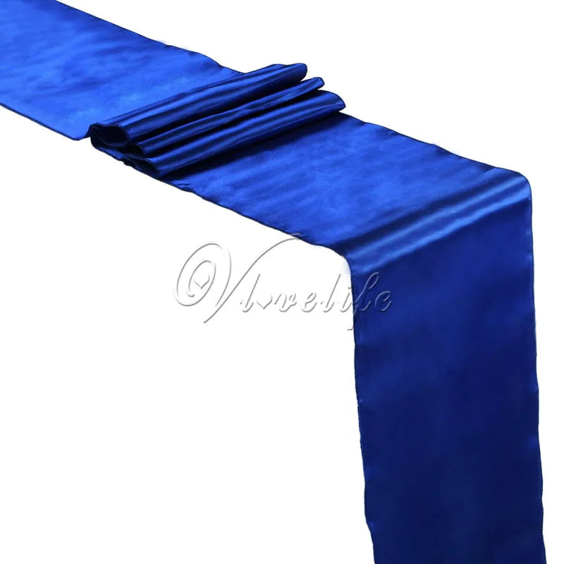 A vibrant royal blue satin table runner draped and folded for an event.