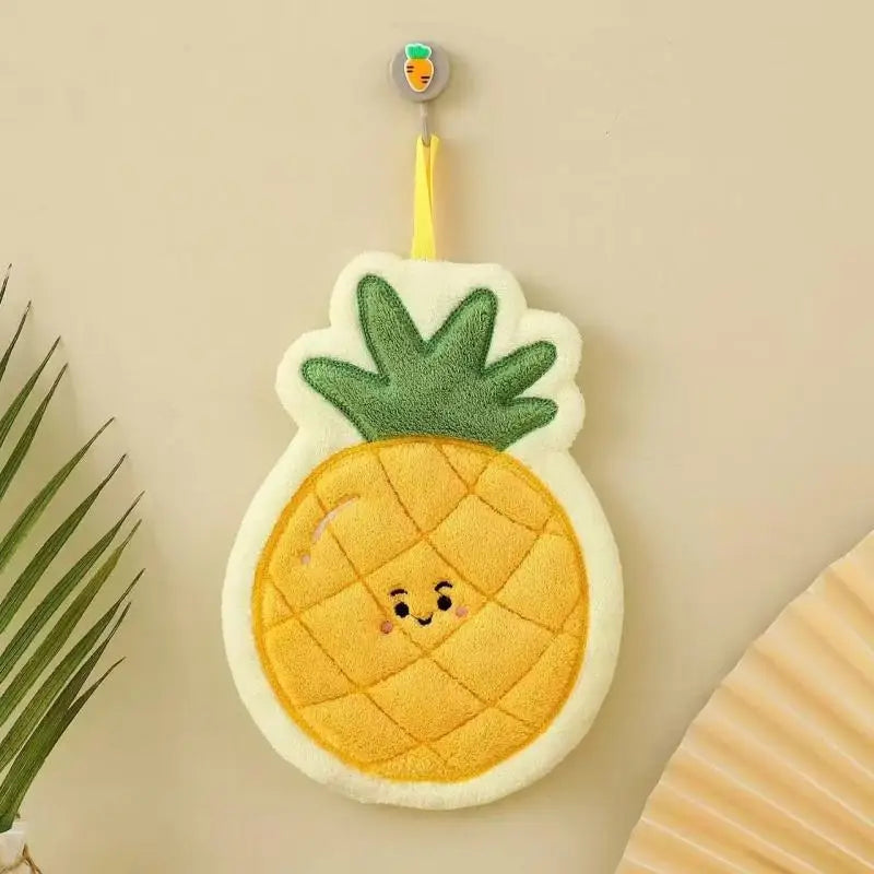 A yellow pineapple shaped coral fleece hanging hand towel with a small hanging loop.