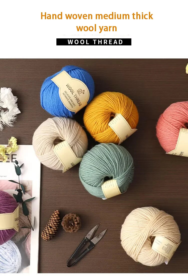 A collection of hand-woven medium thick wool thread in various colors including blue, yellow, beige, and green on a dark wood