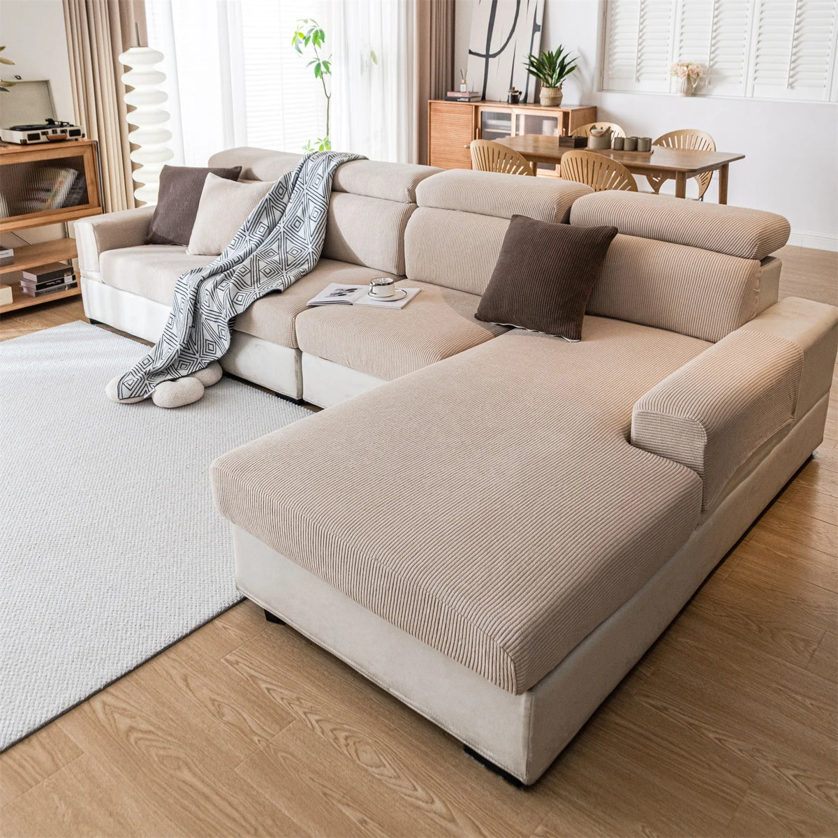 A beige removable jacquard seat cushion cover draped over a light-colored sofa in a bright living room.