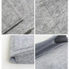 Close-up shots of a gray felt bedside storage organizer with a hanging pocket.