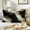 Black and gold marble print decorative pillow cover on a sofa with natural light.