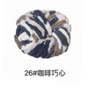 A ball of hand-woven chunky chenille yarn with a gray and white animal print pattern.