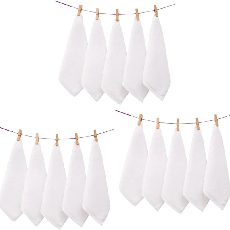 A set of ten white cotton face towels hanging on a clothesline.