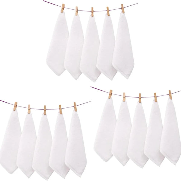 A set of ten white cotton face towels hanging on a clothesline.