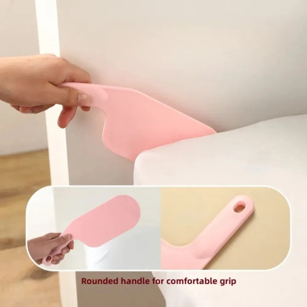 A hand is shown using a pink rounded handle tool for bed sheet folding and organizing.