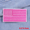 Pink embroidered American flag patch on a denim fabric background