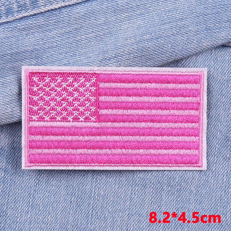 Pink embroidered American flag patch on a denim fabric background