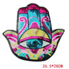 A colorful iron-on patch featuring a stylized blue eye design made with sequins and vibrant colors.