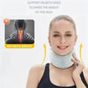 A woman is wearing a light gray cervical neck support brace designed to share the weight of the head.