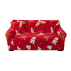 A red festive sofa cover featuring a pattern of gold and white Christmas motifs on a sofa.