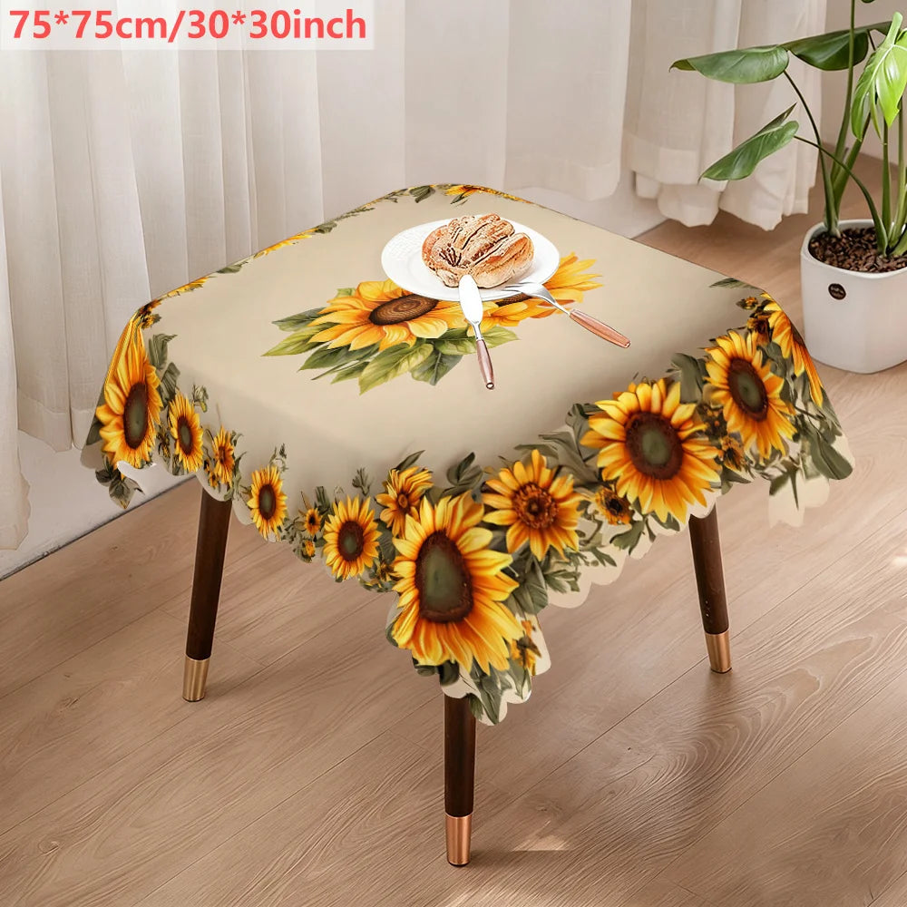 A beige tablecloth decorated with a sunflower floral pattern, featuring a small plate of bread.